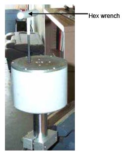 Photograph shows how to attach the upper catch over the guide flange and spring onto the catch flange using a hex wrench. Arrows indicate the correct position for the wrench.