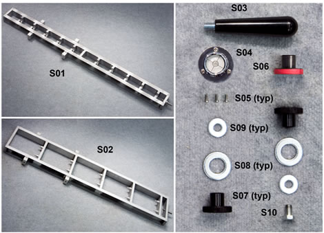 Figure 117. Photo. Equipment for calibration stand assembly. This photo depicts all of the parts necessary for calibration stand assembly except for the KUAB geophone adapter. This includes the geophone stand, seismometer stand, phenol handle, bubble level, Carl Bro adapter, two JILS adapters, bubble level attachment machine screws, two each of the large and small washers, and an attachment bolt.