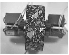 Figure 11 of protocol P07 shows a picture of a typical asphalt core sample with extensometers mounted on either side of the sample
