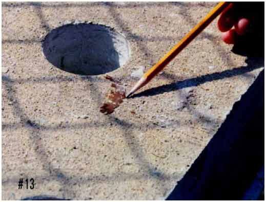 Figure 14. Photo. Rust staining on the top surface of slabs 3 and 4. This photograph shows an example of rust stains on the top surfaces of slabs 3 and 4.