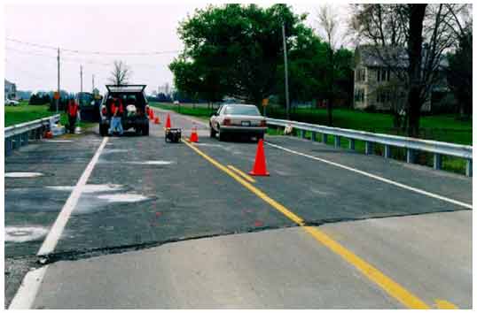 Figure 27. Photo. Deck surface of bridge carrying SR-295 over Blue Creek in Lucas County, OH. The photograph shows the deck surface of a two-lane bridge of SR-295 over Blue Creek near the intersection of SR-295 and Waterville-Neopolis Road in Lucas County, OH.