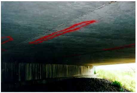 Figure 29. Photo. Delaminated areas (marked in red) on the soffit of the bridge. The photograph shows delaminated areas marked in red on the soffit of bridge carrying SR-295 over Blue Creek in Lucas County, OH, during the third evaluation.