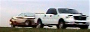 Figure 3. Photo. Class 3 light truck pulling trailer. This photo illustrates a standard pick-up truck pulling a small pleasure boat on a single axle trailer.