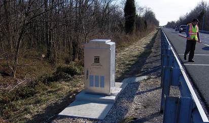 [bottom right] Photo. View of a roadside electronics box, alongside a highway, that collects traffic monitoring data.