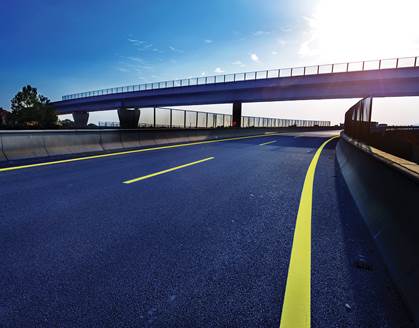 Photo. Asphalt-paved highway. Credit: © hxdyl/Shutterstock.com.