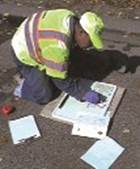 Photo. Worker listing materials samples.