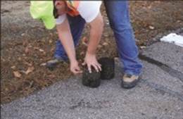 Photo. Worker marking a materials sample core.