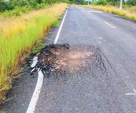 Asphalt pavement distress on two-lane highway.