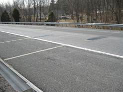 Figure 7.10. Photo. Concrete pavement with staggered bending plate sensors.