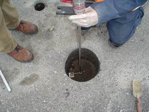 Figure 7.13. Photo. Worker using dynamic core penetrometer.