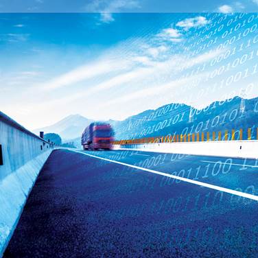 Photo. Truck on highway with ones and zeroes code superimposed. Credit: © gyn9037/Shutterstock.com.