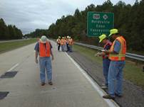 Figure 9.2. Photo. Raters evaluating pavement distress.