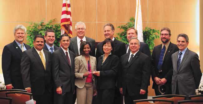 Photo. LTPP team members standing with FHWA senior management after receiving FHWA Administrator's â€œExcellence in Teamworkâ€� award.