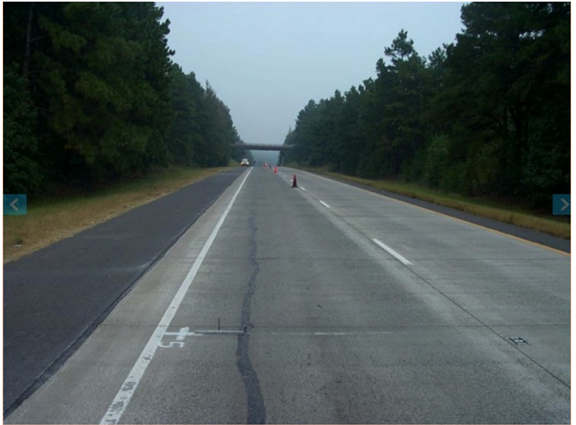 Figure 23. Photo. Longitudinal cracking near the shoulder in Arkansas-0213 section (May 24, 2007).