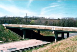 General views of the SR 2042 bridge structures over I-81: A) west bridge and B) east bridge. Photos A and B show that both the west and east bridge spans are supported by two piers, one on either side of the road that the bridge passes over. Each pier has three square concrete columns. 