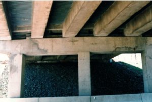 Photo B shows pier 2 and all three columns. The patched area extends from near the first column to near the third column, the entire height of the pier, and down the middle column. 