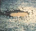FIGURE 30.  Distress Type ACP 8 - High Severity Pothole, Close up View, Color photograph of asphalt concrete pavement with distress type ACP 8 - high severity pothole, close-up view. The area of deterioration is a deep bowl-shaped hole in the pavement containing water and is severely cracked around its edges.