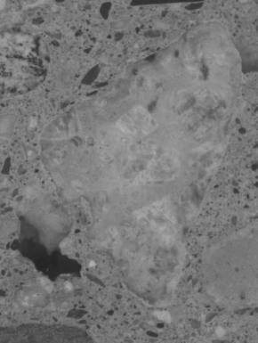  Figure 3-10 (b):  Photographs.  Slab 2B stained with sodium cobatinitrite/rhodamine B from SD-090-019-002.  This figure is comprised of four photographs of slab 2B, labeled A, B, C, and D.  The slab was stained with cobaltinitrite/rhodamine B. Photograph A is a picture of the entire stained slab.  The slab is cracked on the left hand side, but this possibly resulted when the slab was being cut.  Photograph B is of a reactive aggregate particle found in the slab.  Photograph C is a picture of an ASR gel filled void that abuts a larger aggregate particle.  Reaction rims are visible around the aggregate.  Photograph D is of a reactive aggregate particle.