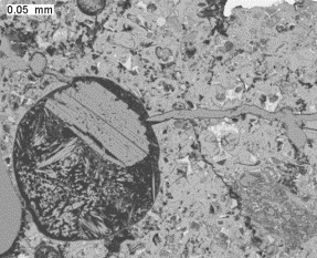   Figure 3-14 (b):  Photographs.  Ettringite in A and hydrocalumite in B infilling in void and crack, respectively.  Example spectra from each phase shown in C and D.  This figure is comprised of four photographs.  Photograph A contains a backscattered electron image of ettringite filling a void.  ASR gel also can be seen filling a crack running through the aggregate particle.  Photograph B contains a backscattered electron image of a crack filled with hydrocalumite.  Photograph C is a spectrum showing that the secondary fill material in the air void is ettringite as the three peaks on the spectrum indicate the presence of aluminum, calcium, and sulfur.  Photograph D is a spectrum from the analysis of the material that is filling the crack in Photograph B.  It is evident that this material is hydrocalumite, as the peaks on the spectrum indicate the presence of aluminum and calcium.