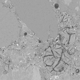  Figure 3-39:  Photographs.  Typical SEM micrograph and X-ray analysis for ettringite infilling air void.  This figure is comprised of two photographs labeled A and B.  Photograph A is an SEM micrograph showing four filled air voids.  Photograph B is a reproduction of the spectrum from the X-ray analysis.  The spectrum shows three peaks labeled aluminum, sulfur, and calcium, which indicates the presence of ettringite in the air voids shown in Photograph A.