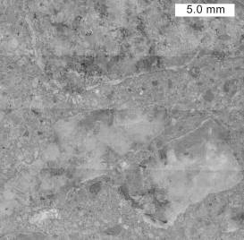  Figure 3-49 (b):  Photographs.  Typical stereo optical micrographs of stained concrete.  This figure is comprised of two photographs labeled A and B.  Photograph A is the result of performing a sodium cobaltinitrite stain.  Photograph B is the result of a barium chloride/potassium permanganate stain.  Note that the broad banding occurs from the montage process to create a single image.