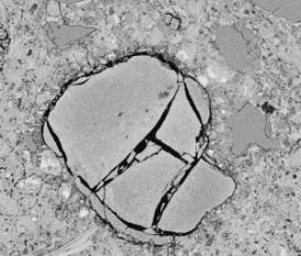  Figure 3-56 (b):  Photographs.  SEM micrograph of ettringite and ASR reaction products.  This figure is comprised of two photographs labeled A and B.  In Photograph A, two ettringite-filled air voids are connected by a crack that is also filled with ettringite.  In Photograph B, an ASR "gel blob" associated with the fine aggregate is shown.  The spectrum shown in Figure 3-57 contain data collected from this deposit.