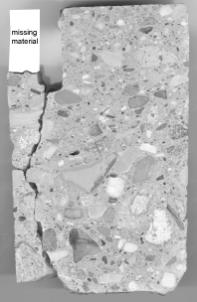  Figure 3-5 (a):  Photographs.  Core specimens from SD-090-019.  This figure is comprised of three photographs labeled A, B, and C.  Photograph A is of a slab from section 001, core B.  The core was taken from the transverse joint and shows evidence of spalling as there is some material missing from the top of the slab.  Photograph B is a picture of core specimen SD090002A and is from section 001.  The core was taken from the transverse joint area and has a steel dowel bar running through the center of it.  The core was taken from the road surface to a depth of 19 centimeters.  Photograph C is a picture of core specimen SD090002C and is from section 001.  The core also is taken from the road surface to a depth of 19 centimeters.  A thin crack can be seen running through the bottom third of the core.
