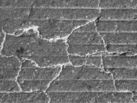  Figure 3-63 (c):  Photographs.  Typical conditions at CA-058-141.  This figure is comprised of three photographs labeled A, B, and C, which show typical distress patterns for this site.  Photograph A shows map cracking throughout the site with some longitudinal cracks being more open.  Spalling is also visible at some of the interconnecting cracks.  Photograph B shows a slightly closer view of map cracking occurring near a longitudinal joint.  Photograph C is a close-up of the map cracking where exudates have come up and filled the cracks.