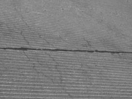  Figure 3-82 (b).  Photographs.  Close-up view of longitudinal hairline cracks.  This figure is comprised of two photographs labeled A and B.  Photograph A shows some map cracking and hairline cracking throughout the concrete.  A hammer was placed in the image to give a sense of perspective.  Photograph B also shows hairline cracking.  Both photographs are of the wheel path area of the roadway.