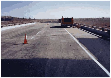 The figure consists of a photograph of the treated section of the Boron overhead structure. There are two lanes of traffic and a shoulder.