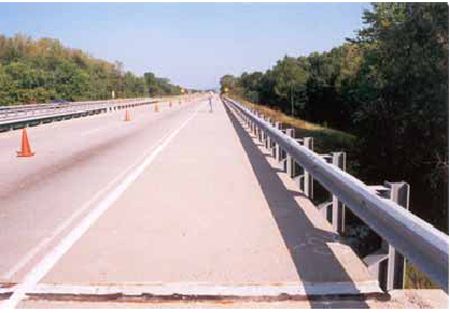 Photograph showing the westbound travel of lane of U S 52 over Raymond Run in Columbus, Ohio. The overlay is latex-modified.