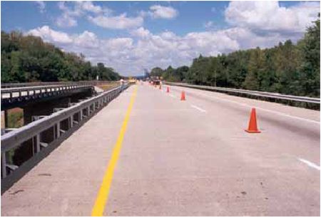 Photograph showing the westbound passing lane of U S 52 over Raymond Run in Columbus, Ohio. The overlay is silica fume-modified concrete