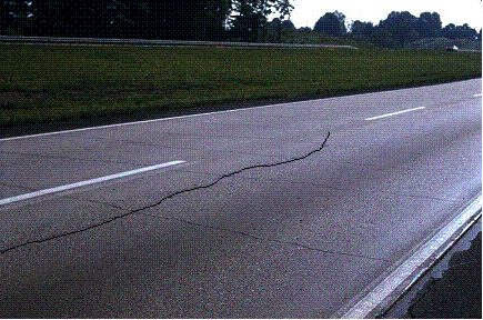 Figure 20.  Photo.  Longitudinal crack in CRCP due to thermal shock.  Crack is enhanced for clarity.  Photo depicts many transverse crack as well an enhancement of a longitudinal crack in CRCP due to thermal shock, which is the object of interest.