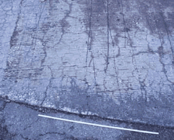 Photo shows the surface of a concrete deck with cracking.