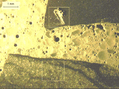 A section of concrete is shown with a piece of limestone coarse aggregate, a piece of quartzite coarse aggregate, and air-entrained mortar between the two larger aggregate particles. 