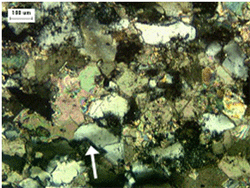 Here light is passed through a very thin section of rock, showing the individual mineral grains and their relative color and shape.