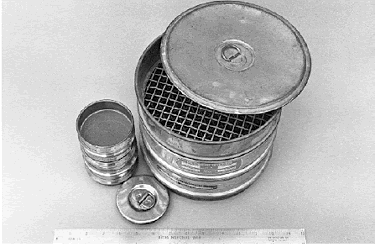 Two sets of A S T M E 11 standard sieves are shown. One set is of 76-millimeter diameter frames and the other is of 203-millimeter diameter frames. Both sets have covers. 