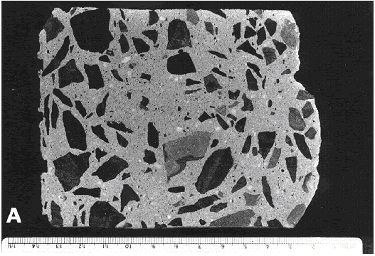 Photo is of high paste content with a coarse and medium sized aggregate of a fine-grained metamorphosed shale, and a fine aggregate of quartzose sand. By visual inspection of the unaided eye, the paste covers about 40 percent of the total surface area.