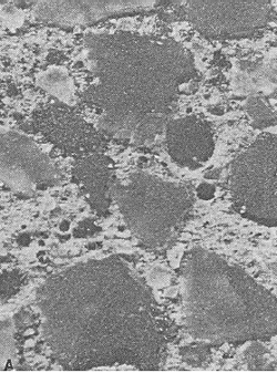 Photo is a section of the mortar phase of concrete, and it shows the etched surface on a concrete with quartz sand fine aggregate in which the paste was undercut. The outline of the quartz sand particles is easily identified. The width of the image is 10 millimeters.