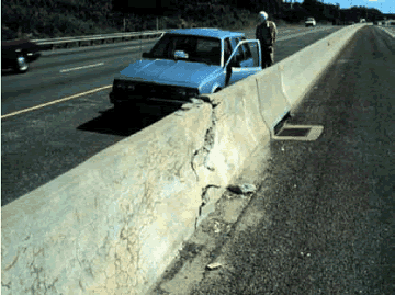 Expansion caused by A S R of quartzose coarse aggregate caused a median barrier to crush itself. A large crushed concrete zone with a diagonal crack is shown in a Jersey-type median barrier. Other random cracking due to A S R is present as well.