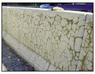 Figure 3. Concrete Barriers along Route 2 Near Leominster, Massachusetts. This photo shows several horizontal cracks along two sections of concrete barriers, and the cracks are connected by several vertical cracks.