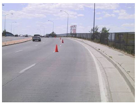 Figure 15.  Photo. General View of Lomas Boulevard Experimental Pavement. This photo shows three lanes of pavement.