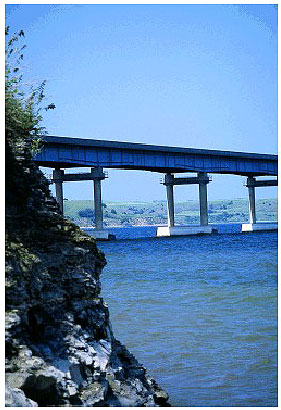 Figure 31.  Photos. Repair of Pile Caps on Platte Winner Bridge, SD. This photo shows the Platte Winner Bridge, which is supported on piers with two columns each anchored to a pile.