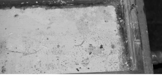 Part 3: These three pictures show the concrete surface at different stages during the surface study outlined in figure 12.  The top photograph shows a white substance covering the surface of the concrete with tiny cavities that resemble little craters in some areas.  The middle photograph shows a bare concrete surface (concrete pores exposed), with the white substance completely removed. The bottom picture exhibits the formation of white material inside the large concrete pores that were exposed during sandblasting.