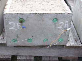 Figure 48. Slab #2 front, rear, and top views with specifications. Photos. (A) Slab number 2 front view shows the 2B label on the left and 2A on the right. The top has two green spots indicating bars and the bottom left bar has a corrosion spot while the concrete and the rest are clean. Wires connect the top and bottom bars of 2B and the same for 2A.