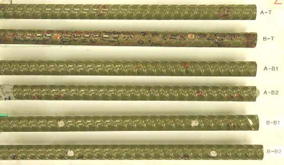 Figure 49. Slab #2 extracted rebars condition. Photo. Before autopsy, the top mat straight ECRs are shiny olive green. The second from the top ECR (B-T) shows deteriorated coating condition.