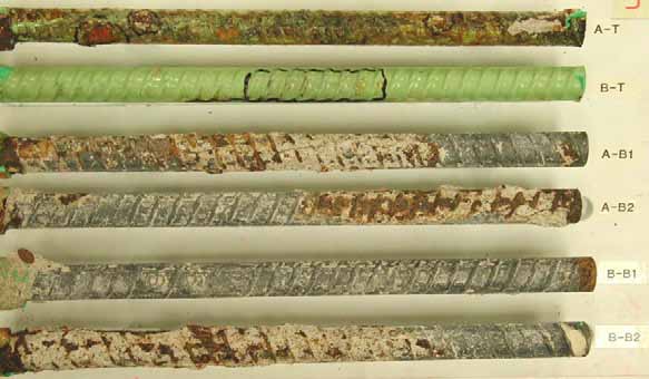 Figure 52. Slab #3 extracted rebars condition. Photo. Before autopsy, the top mat straight ECR (A-T) looks mossy green with hairline cracks and coating blisters. The second ECR is spring green with hairline cracks in the center. The bottom mat four black bars show white concrete residue encrusted with rust. 