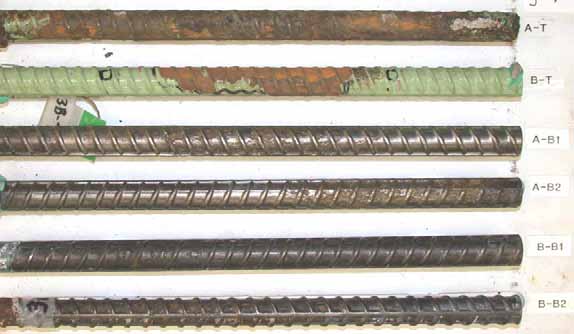 Figure 53. Slab #3 after autopsy. Photo. After autopsy, a top mat ECR (A-T) is completely delaminated with corrosion spots, the second top mat ECR (B-T) is lime green with significant delamination and corrosion in the center, and the cleaned bottom mat four black bars look good with minimal corrosion damage.