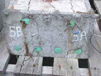 Figure 57. Slab #5 front, rear, and top views with specifications. Photos. (A) Slab number 5 front view shows the 5B label on the left and 5A on the right. The top bars show corrosion and the first and second from the left on the bottom have corrosion with cracks throughout. Wires connect the top and bottom bars of 5B and the same for 5A. 
