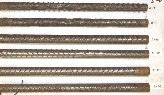 Figure 59. Slab #5 after autopsy. Photo. After autopsy, two top mat black bars (A-T and B-T) reveal significant metal loss due to intensive corrosion The cleaned two bottom mat black bars (A-B1 and B-B2) show moderate pitting corrosion. The remaining two bottom black bars (A-B2 and B-B1) show shiny surfaces with generally good condition except for rust on the right end of B-B1.